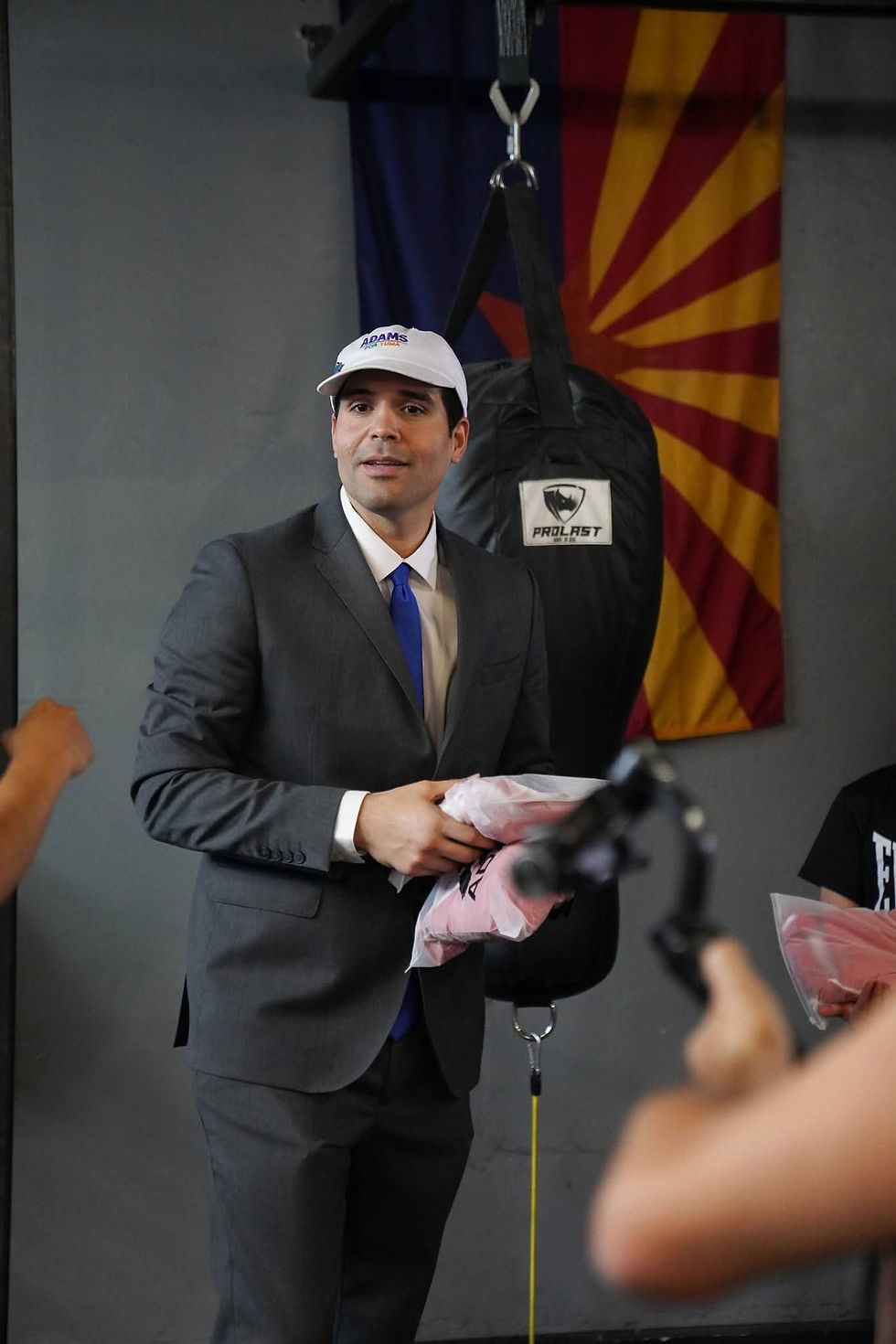 Carlos Adams at a boxing community event with the Arizona flag